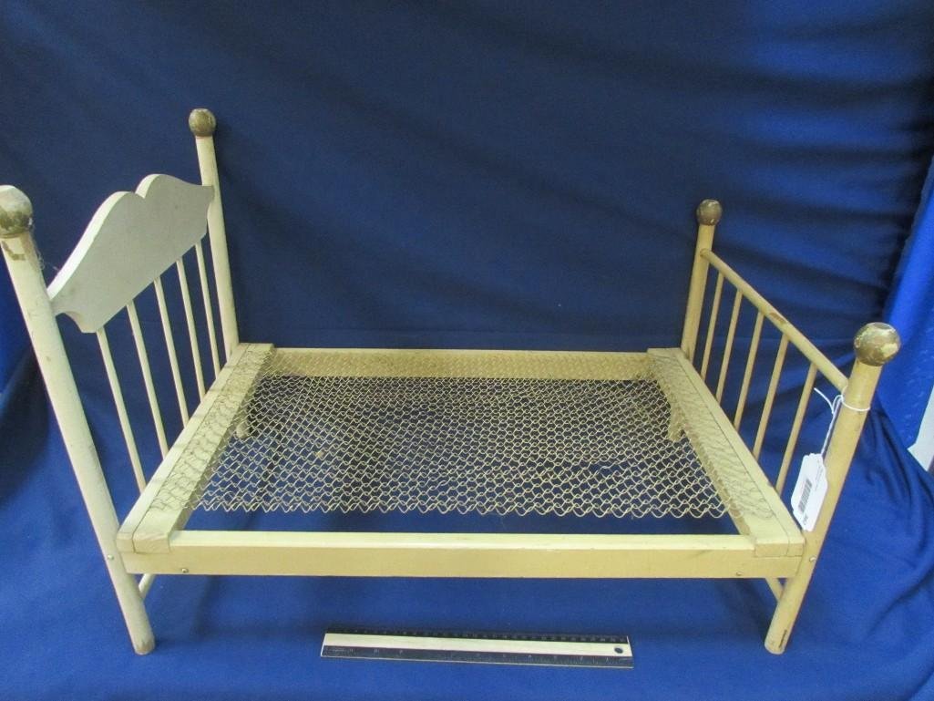 Vintage Doll Bed Frame: Has wire mesh for mattress. Shows age. Measures 18" tall, 26" long and 15 1/2" wide. Made from wood. Folds up. 