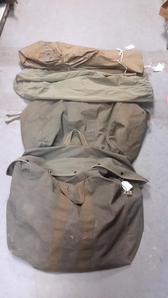April 1975 Kit and Cargo Bags (4): 1 has drw string, 1 has wrap around tie marked US Dick Blackwell sleeping mountain cover only, US Kit bag Flyers has zipper closure and handles, last bag marked kit bag, flyers ind. F-T VLIND, da