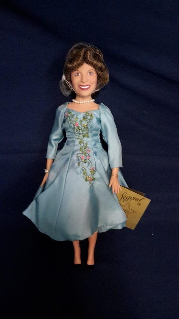 Gracie Allen Doll: Legend Series by the Effanbee Doll Company. Has stand and measures 16" tall. Still in plastic wrap with hair net on.