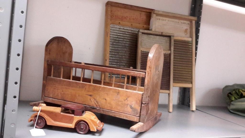 Washing Boards, Cradle and Musical Car (5): Wood car is a windup music box. Cradle measures 13 1/2" tall x 20" long and 14" wide and has VL carved in the end, shows age. Have 3 wash boards; smallest measures 18" tall x 8 1/2