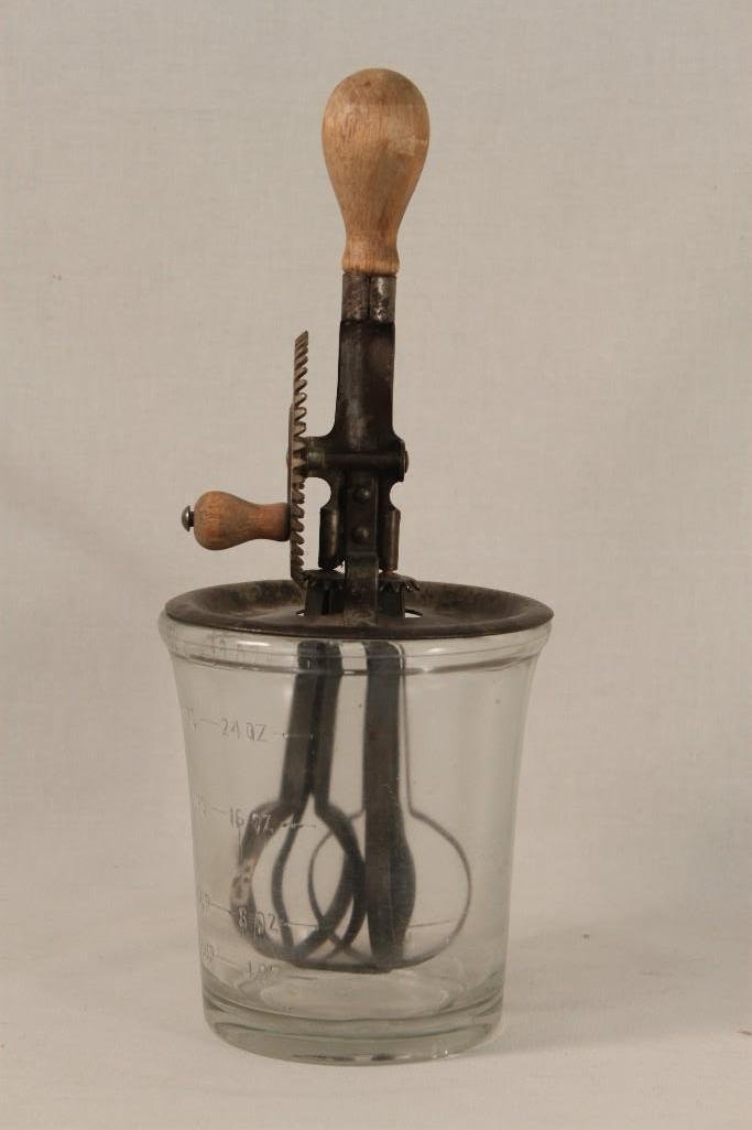 Vintage A & J Egg Beater with Glass Measuring Cup: 4 cups, Made in USA, turns nicely, measures 12 1/2" tall, diameter 5". A couple of small chips along top of measuring cup. 