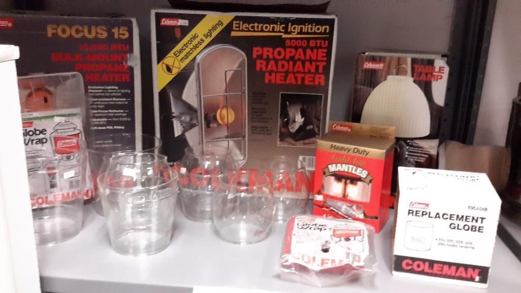 Coleman Camping Goods: Two propane heaters and table lamp. Box of mantels, replacement gloves, globe wrap x2. 