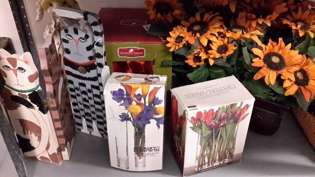 Home Decor: Lot includes clear glass flower vases in original packaging, garden gazing ball, artificial sunflowers, and more 