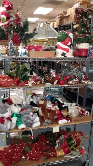 Large Assortment of Christmas Decorations: Some items include a Santa clause cookie jar, vintage Christmas tree in a boot, rope lights, stuffed animals, elves, Christmas tree decorations, and much more.