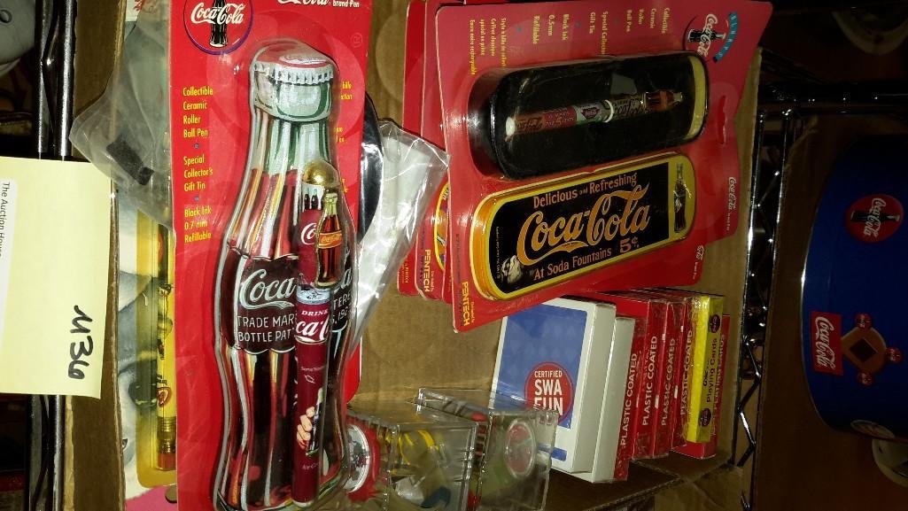 Small Coca- Cola Collectibles: New playing cards, two watches in boxes, new pen, trays, pencils, tin, new in package pens with tin and more.