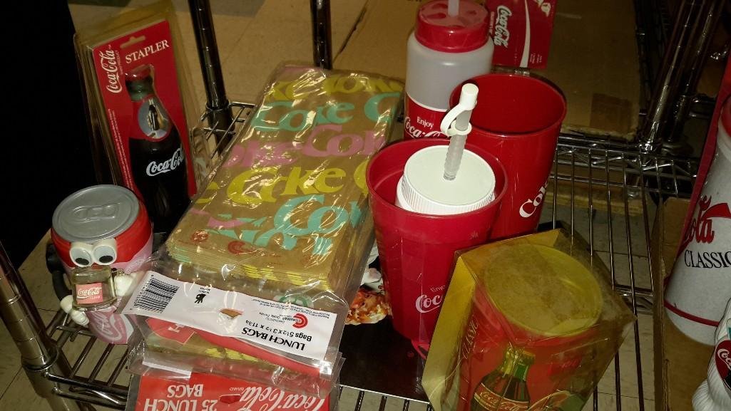Coca-Cola Collectibles: Lunch bags, cups, coaster, stapler new in package, and more.