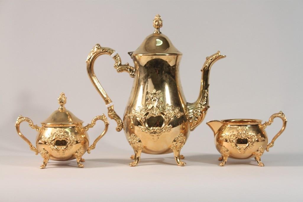 Gold Metal Tea Pot, Cream and Sugar Set (3): Footed tea pot measures 11" tall. Footed cream measures 4", sugar measures 5 1/2". 