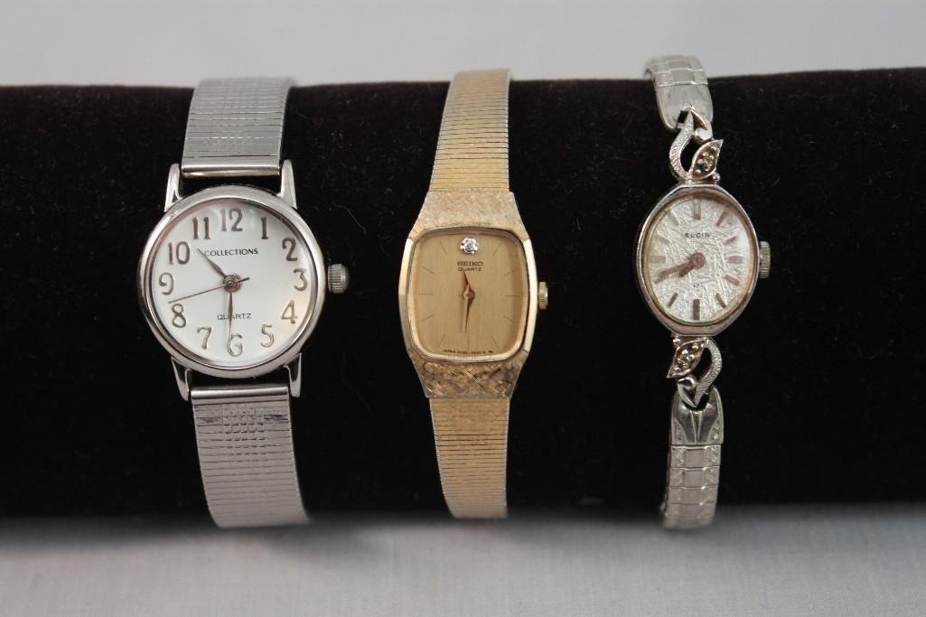 Ladies Wrist Watches (3): One silver tone Collection watch, one Elgin silver tone watch with stretch band, and a Seiko gold tone quartz watch