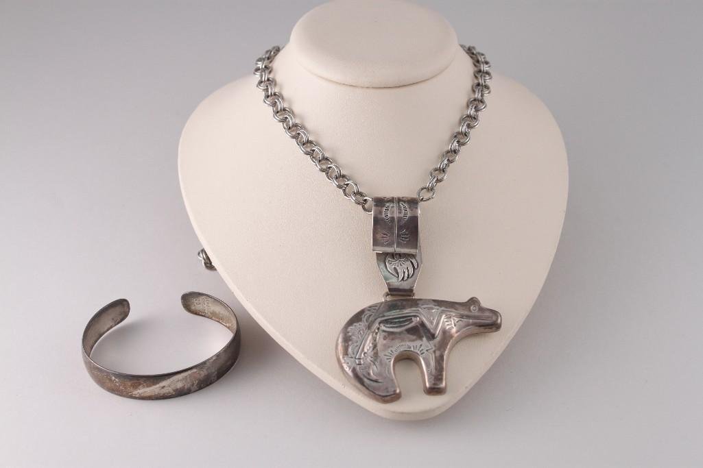 Sterling Silver Pendent and Bracelet: Sterling bear pendant on a silver tone chain and a small sterling cuff bracelet (shows tarnish) marked S. Kirk & Son 20