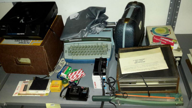 Vintage Typewriter and Film Assortment: Lot includes Smith Corona type writer, 8 track Transport Tape player, Minolta Autopak; 600-x camera, show pak 300 in carrying case, Sylvania; Sun Gun movie light, and much more