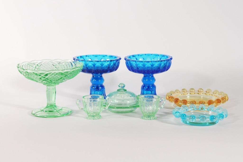 Vintage Colored Glass Decor (8): Blue and amber glass ashtrays with beaded edges, green steamed candy dish (4" tall), miniature green cream and sugar (1.5" tall), miniature lidded bowl, pair of blue glass candle stick holde