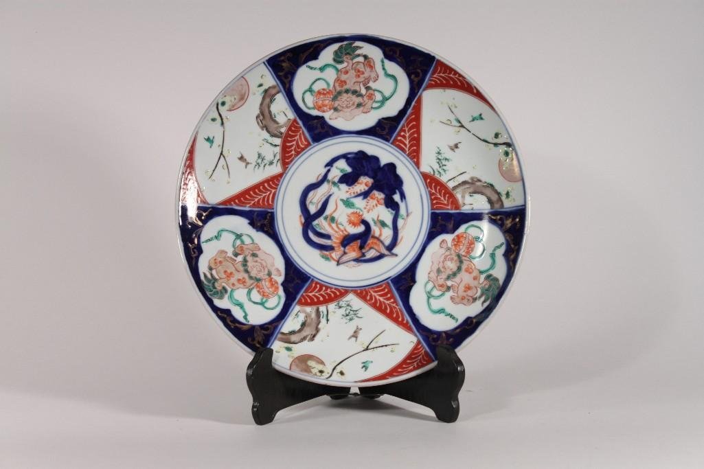 Antique Imari Charger: Japanese porcelain 12" diameter charger, decorated with fans and medallions with phoenix in middle, lotus flowers, birds and foo lions, some small scratches from age