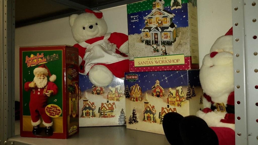 Christmas Decor: Lot includes (2) Mervyn's 1994 Village square 5 piece miniature house sets, animated Santa's work shop, a jingle bell rock Santa, and two plush toys 