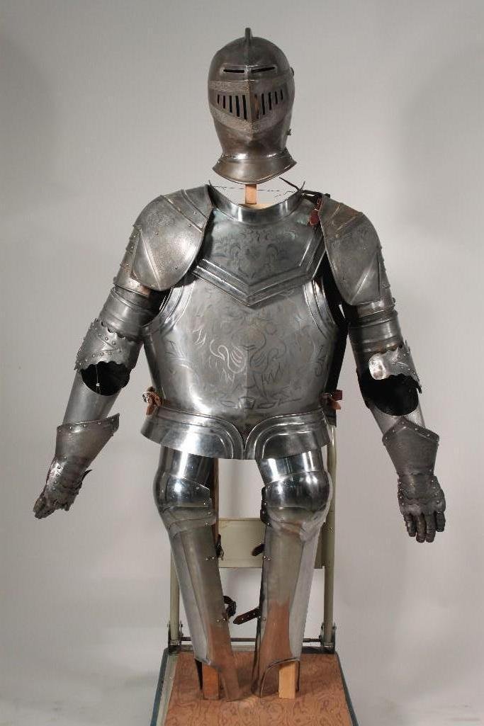 Medieval Suit of Armor: Includes; leg guards with leather straps, breast plate and back plate with leather straps at the waist and shoulder. Shoulder, elbow guards, gauntlets, and face guard have intricate etching.