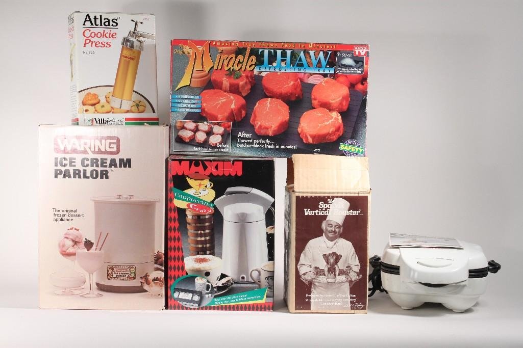 Small Kitchen Appliances (6): Waring Ice Cream Parlor in original box. Maxim Cappuccino Machine in box, a Miracle Thaw defrosting tray. A Black and Decker Shell baker and more.