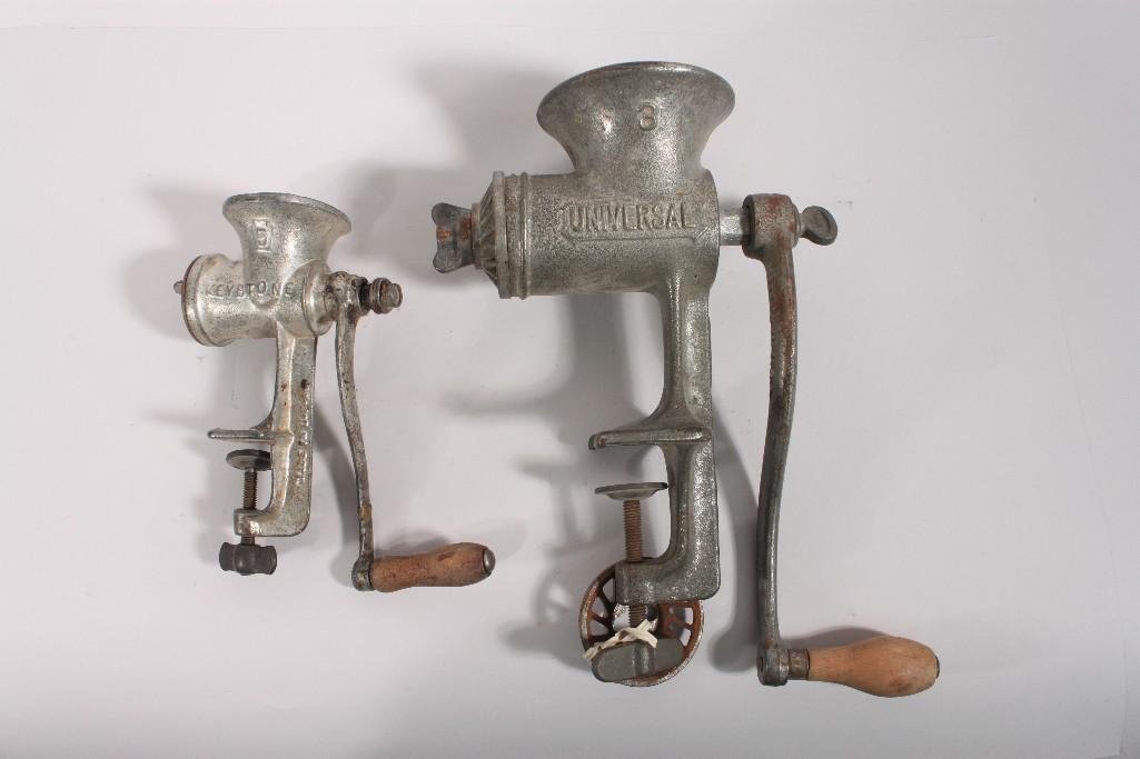 Vintage Meat Grinders (2): Table mounted Grinders, one Universal brand 11 inch tall and one Keystone 8 inch tall grinder.