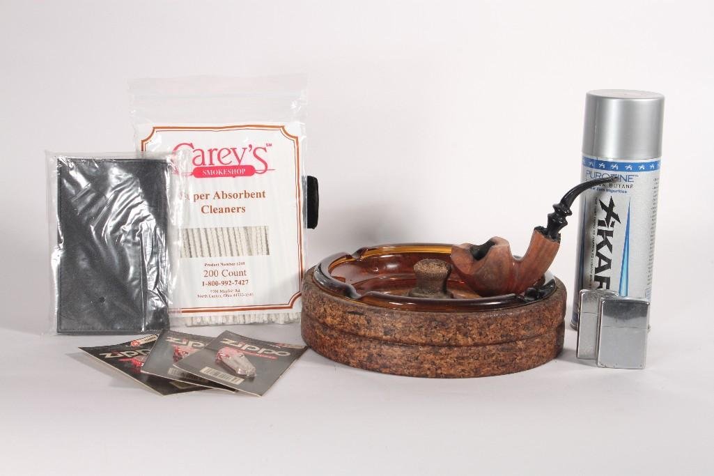 Tobacco Pipe and Accessories: Lot includes (2) Zippo lighters, wood carved tobacco pipe, Cork and glass large ashtray, zippo flints, and more 