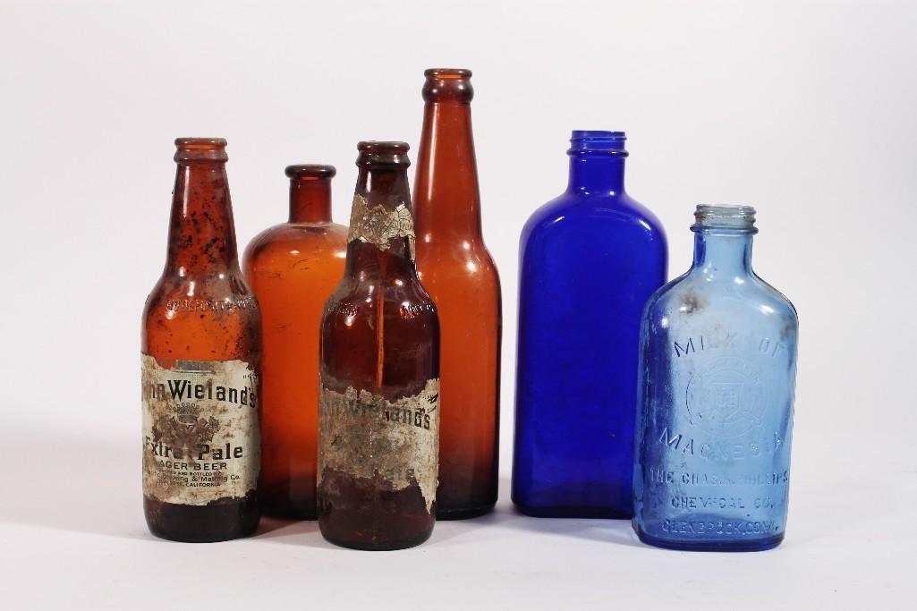 Vintage Amber and Blue Bottles (6): Includes two Milk of Magnesia bottles, two John Wieland extra pale amber beer bottles. Ranging in size from 7 to 10 inches.