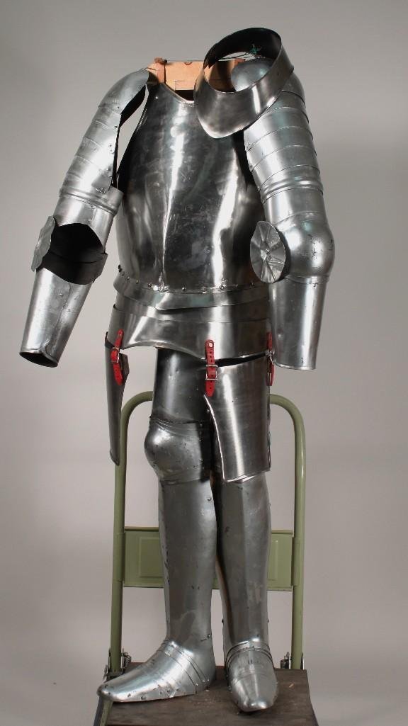 Reproduction Medieval Armor: Chest and back plate, arm and shoulder guards, leg and feet guards, and gorget, shows some wear.