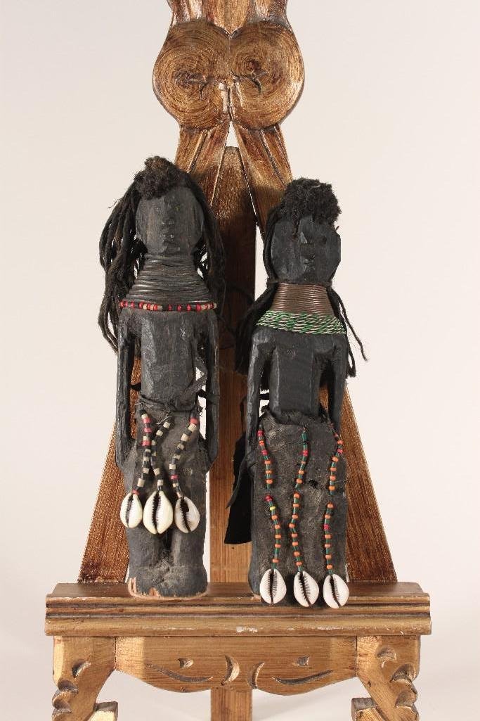 Hand Made Wooden African Dolls (2): Black Wooden 9" Boy doll and a 8 3/4" tall Girl Doll with shell and beaded costumes and mop-type hair.