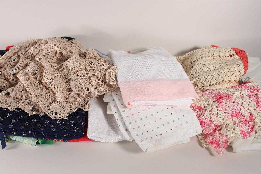 Vintage Aprons and Linens: Items include: cream table clothe with green embroidery, red waist apron, green waist apron, dish towels, two knitted aprons, doilies, and more. 