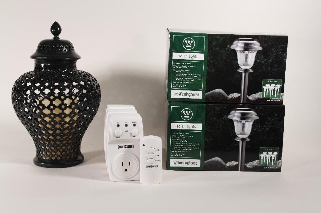 Indoor and Outdoor Decorative Lighting: Items include: SuperSwitch Wireless Remote Control Wall Outlets in box, brand new. 12" tall black lantern with flame less candle. Two boxes of Westinghouse solar lights, each box has a set o