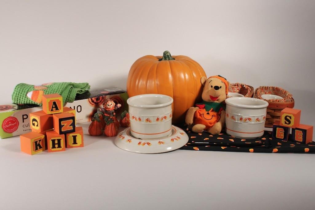 Halloween Decor: Items include: plastic pumpkin, candy corn place mates, paper napkins, dish towels, and more.