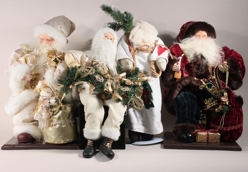 Santa Collection (4): 21" White and gold Santa on wood stand, 20" plush Santa on metal stand, burgundy and gold 21" tall Santa on wood stand, and a white and gold sitting Santa