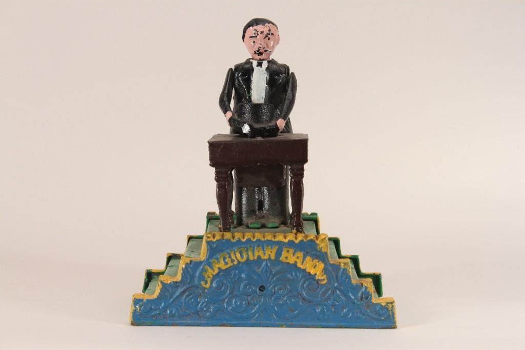 Vintage Iron Collectible Bank: reproduction mechanical Magician bank measures 7.5" tall, marked made in Taiwan, shows some wear