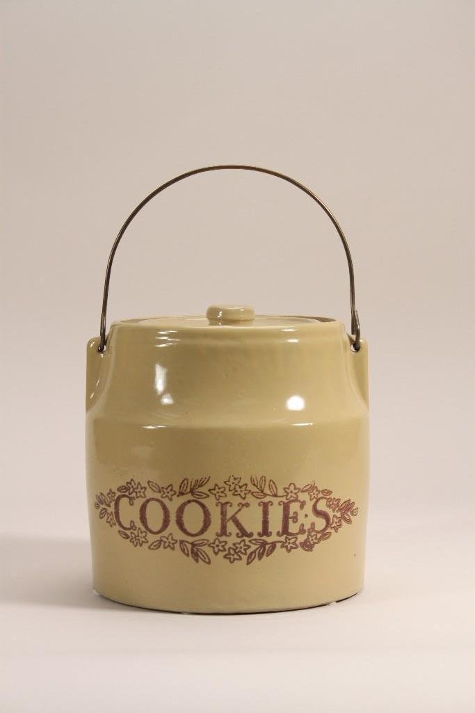 Vintage Cookie Jar: marked Monmouth Ill USA, wire metal handle, measures 7.5" tall, in good condition.