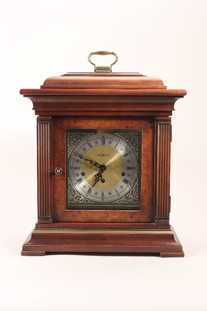 Howard Miller Mantel Clock: Triple chime key wind movement. Nice wood case, metal faced. 14" x 14.5" x 8".
