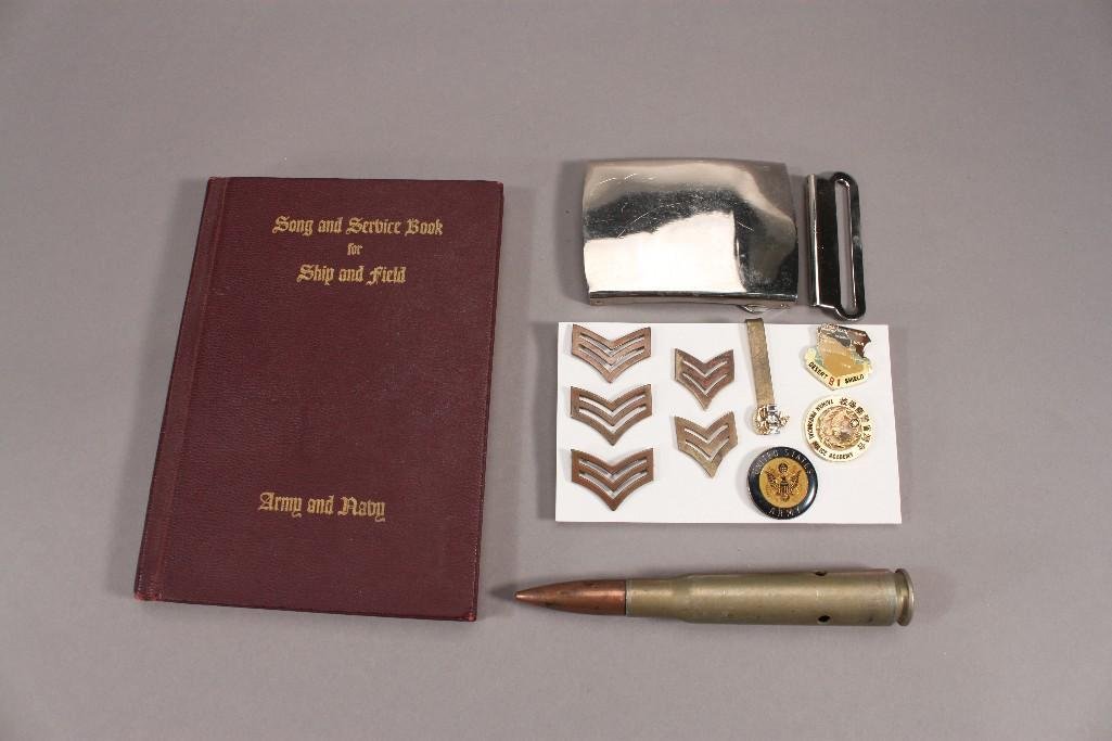 Military Song & Service Book and Pins: 1942 Army Navy Service Book, silver metal belt buckle, US Army 50 caliber inert shell, and several uniform pins.