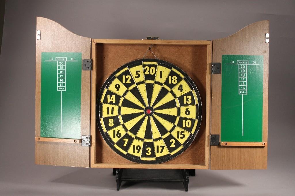 Dart Board In Cabinet: Cork dart board measures 20"x15.5", the front is painted and says "The King Of Arms", shows wear.