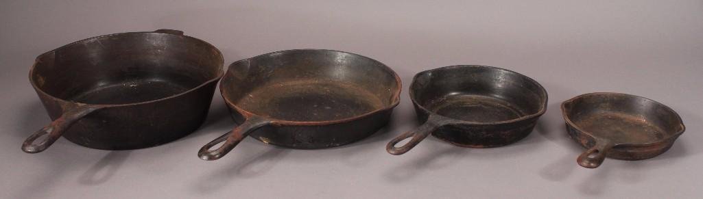 Vintage Cast Iron Skillets: One Griswold No. 8 frying pan, an unmarked 3.5" deep skillet, and two small skillets 