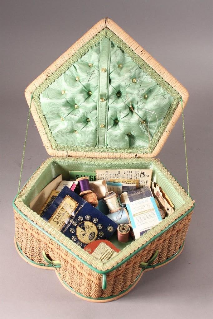 Vintage Sewing Basket and Contents: Woven basket with green satin lining measures 12"x10"x5". Contents include: snaps,hook eyes and loops, thread, and more.