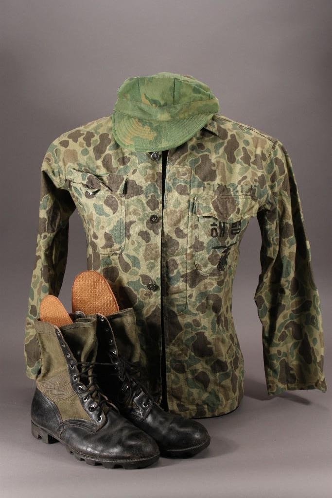 Military Clothing (3): Items include: Original USMC Vietnam Camo Hat, Korean Camo Advisor Shirt with name Frazee above left pocket, a pair of size 9w Genesco green and black boots.