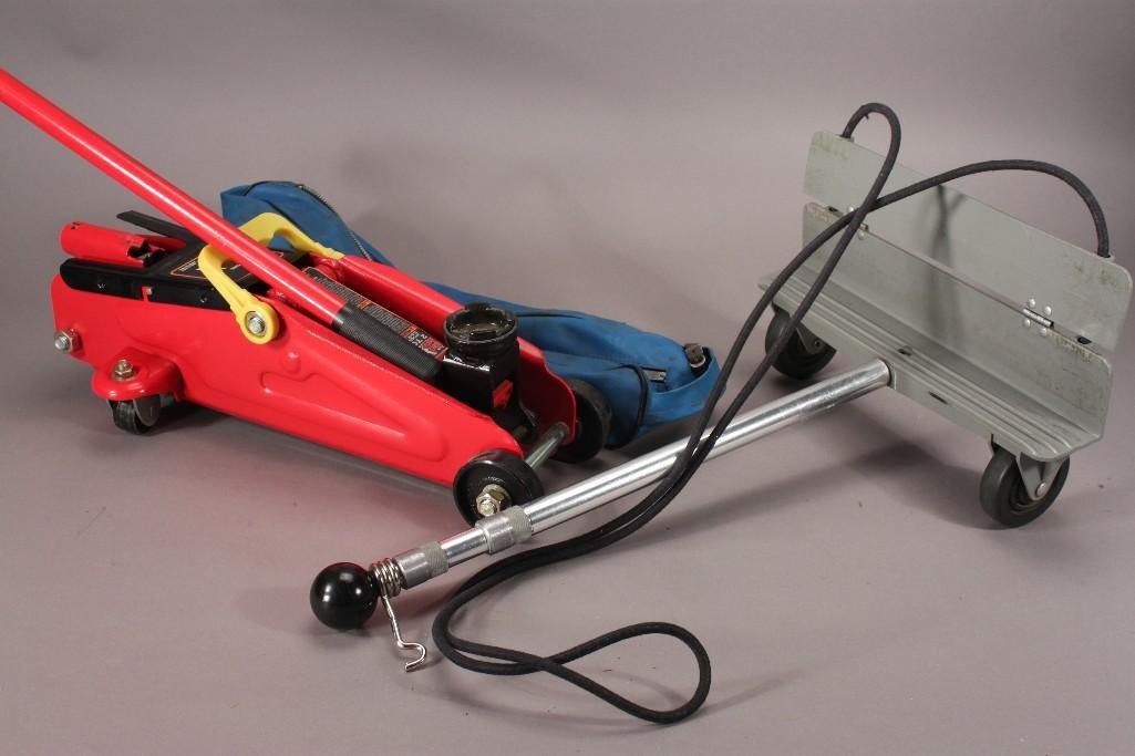 Floor Jack and Luggage Carrier: Torin Big Red Two Ton Hydraulic Floor Jack, a luggage roller, a blue canvas bag, and a Remote car starter.