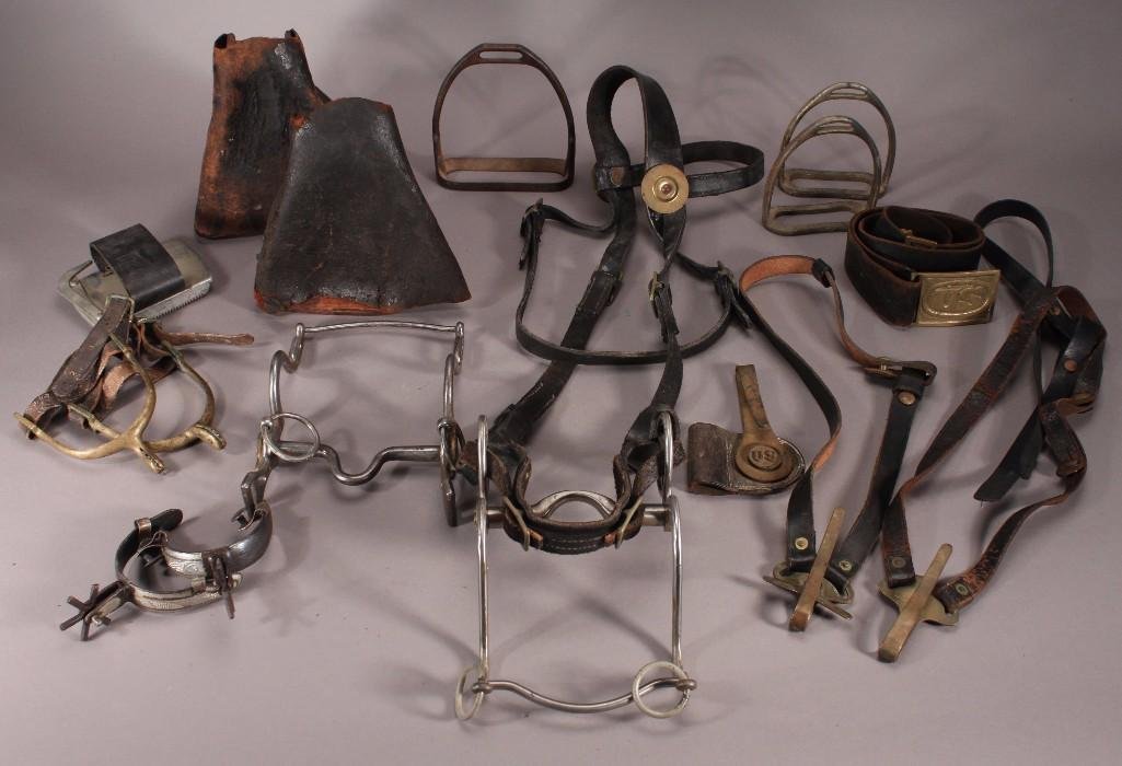 US Military Horse Bridles, Stirrups, Spurs, and Bits: Assortment of old stirrups, bits, bridles, and spurs. Leather straps, one pair gold leather cover stirrups, two bits marked US.