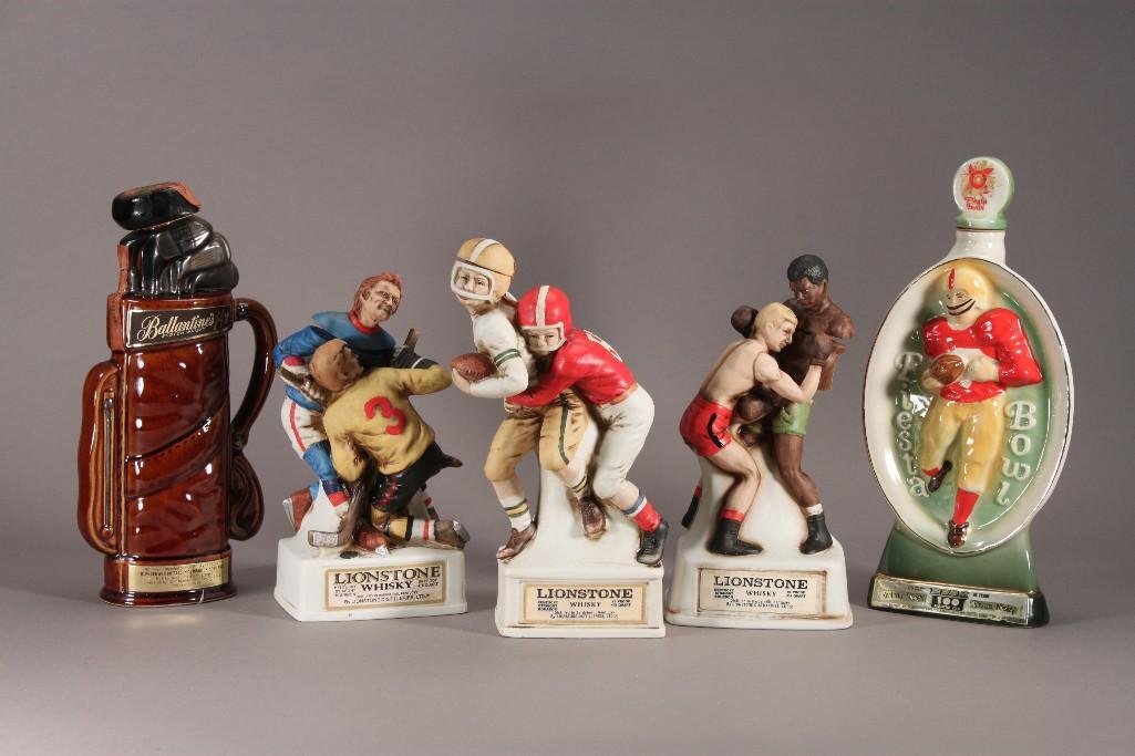 Sports Themed Vintage Decanters (5): (3) are 1974 Lionstone Whiskey, boxing, hockey, and football sculpted porcelain figures. 1969 Ballantine's Whiskey golf bag decanter, and 1973 Fiesta Bowl Beam decanter