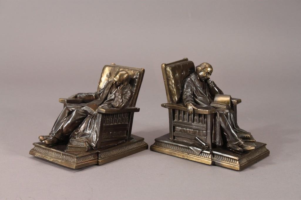 K & O Co. Metal Bookends (pair): Metal bookends of a man sitting in a chair measure 4" tall. One has some damage to the back where it has been pressed down. Marked K & O Co. Made in USA on the back.