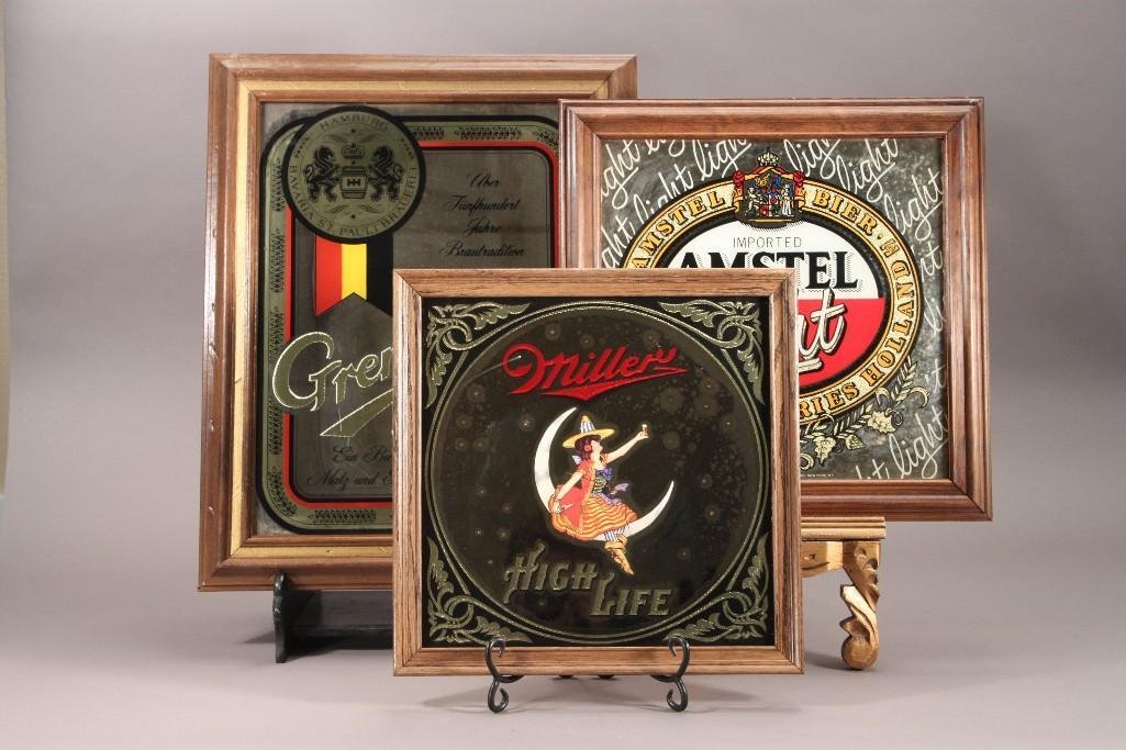 Beer Advertisement Mirrors (3): Includes a Imported Amstel Light 16" x 16.5" wood frame (has crack in right corner), Miller high life 14" x 14" with wood frame, and a Grenzquell 16.5" x 21" with wo