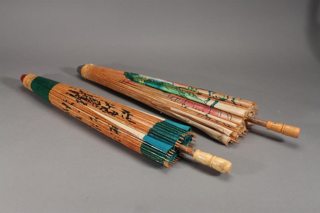Asian Style Paper Parasols (2): Blue and beige paper parasol has wood frame and handle some rips in the paper, and a floral parasol has wood frame and handle has multiple small rips in paper, and two large rips one is covered with t