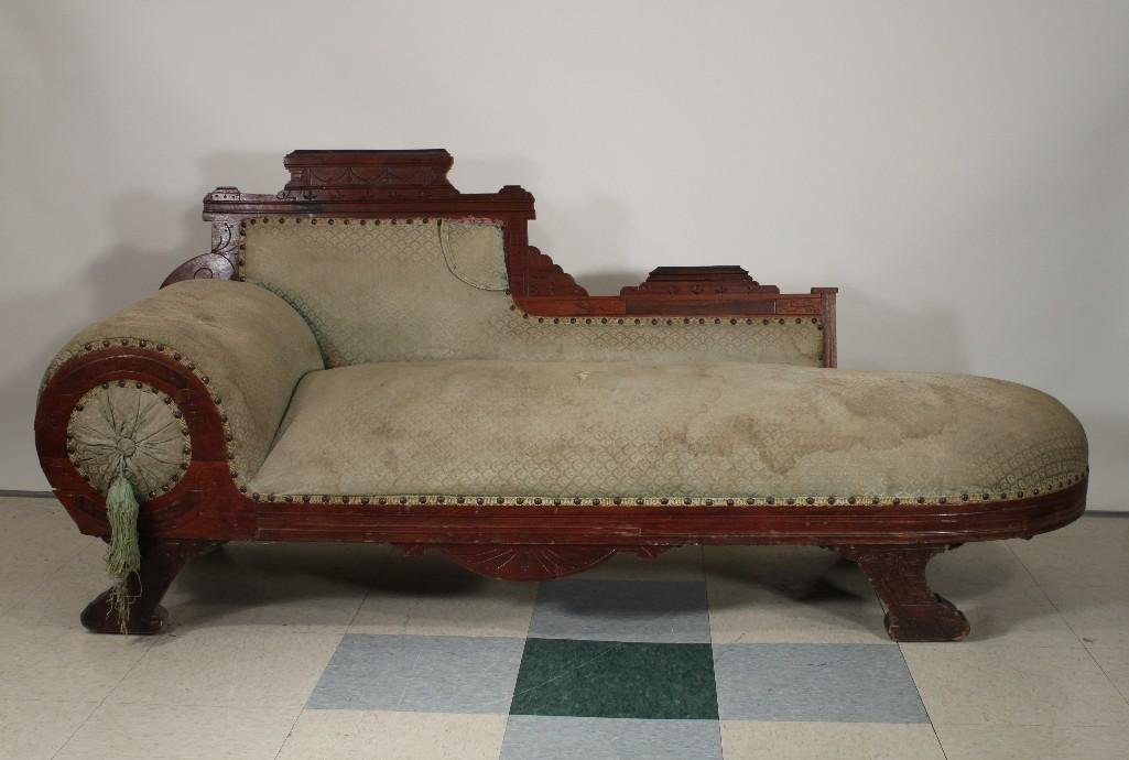 Antique Fainting Couch: Carved wood frame, upholstered with nail head trim, needs reupholstering. Measures 71" long, 30.5" tall, 22" deep.