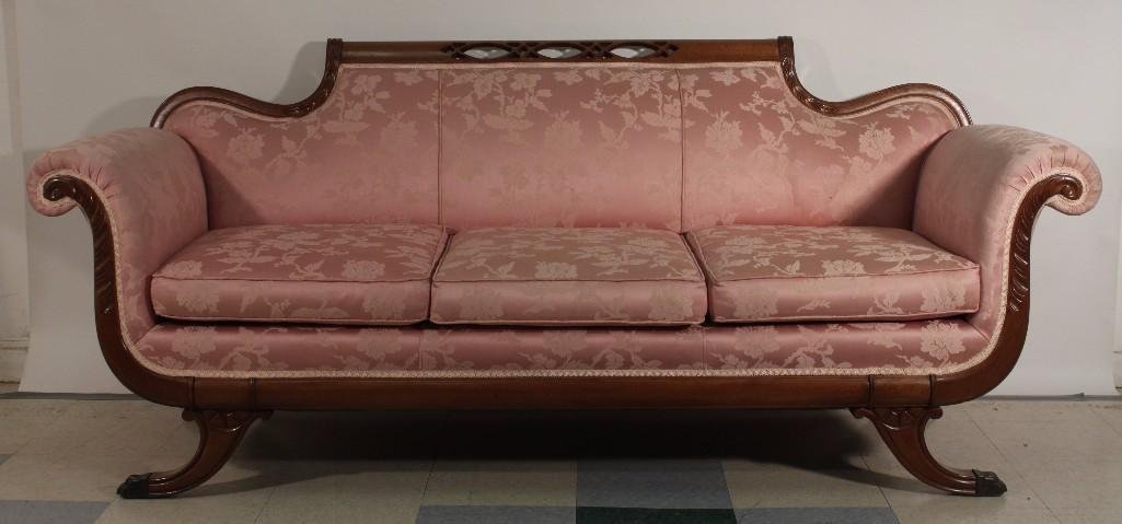 Duncan Phyfe Style Antique Sofa: Oak framed, claw footed sofa. Pink floral pattern upholstery. Reticulated carved top rim. Metal claw feet caps. 80" long, 34" high, 32" deep. In good condition