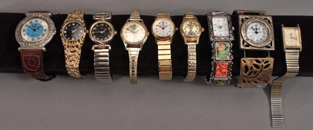 Ladies Wrist Watches (8): One Geneva, one Avanti, several that say Quarts (only), one Chico watch missing pin, one Focus. Some silver tone, some gold tone, one has a broken band and an extra band is included.
