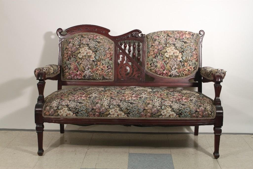 Victorian Settee: Floral upholstery with detailed wood frame has carved in spindle wood design measures 51"x35"x21"