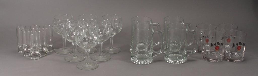 Clear Glass Barware(20): Lot includes four Jim Beam glasses that measures 4'' tall, six 5.5'' tall wine steams, four 5.5'' tall beer mugs and six 4'' tall shot glasses. 
