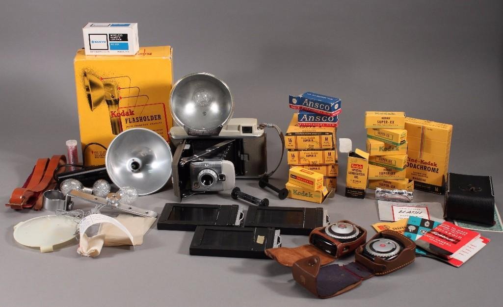 Polaroid Land Camera and Camera Accessories: vintage Polaroid Land Camera Model no. 80, Kodak flash holder with standard bracket, Cine-Kodak super-x film magazine NIB, Kodak super-xx film, and more.