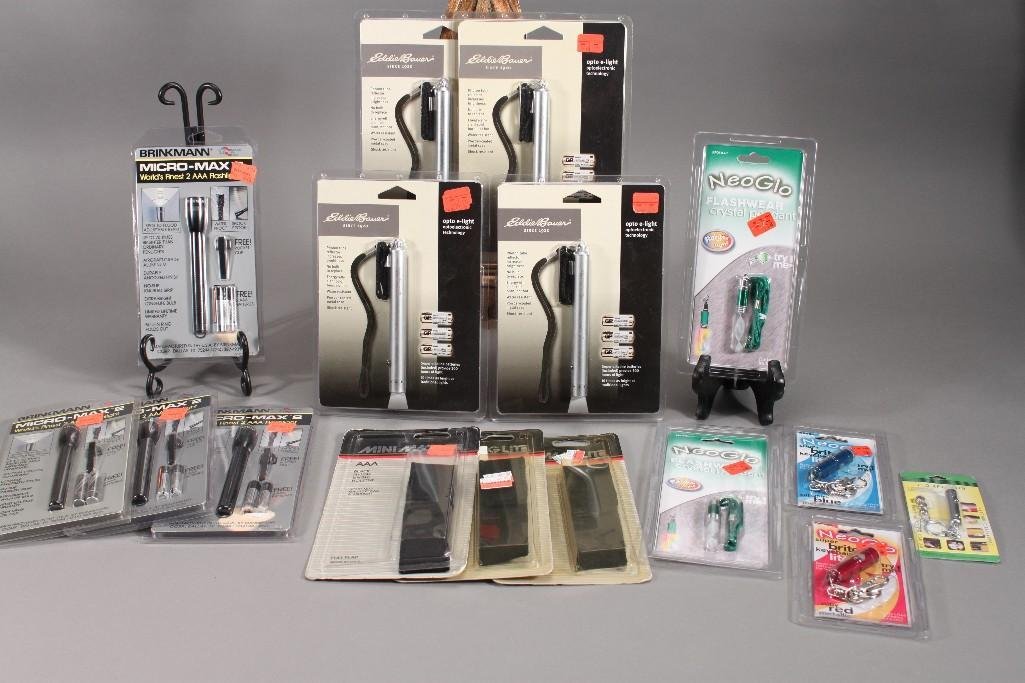 Eddie Bauer and Keychain Flashlights (15): Includes five keychain flashlights, three black nylon single flashlight holsters, four Brinkman Micro-Max 2 flashlights, and four opto e-lights. All are in original packaging.