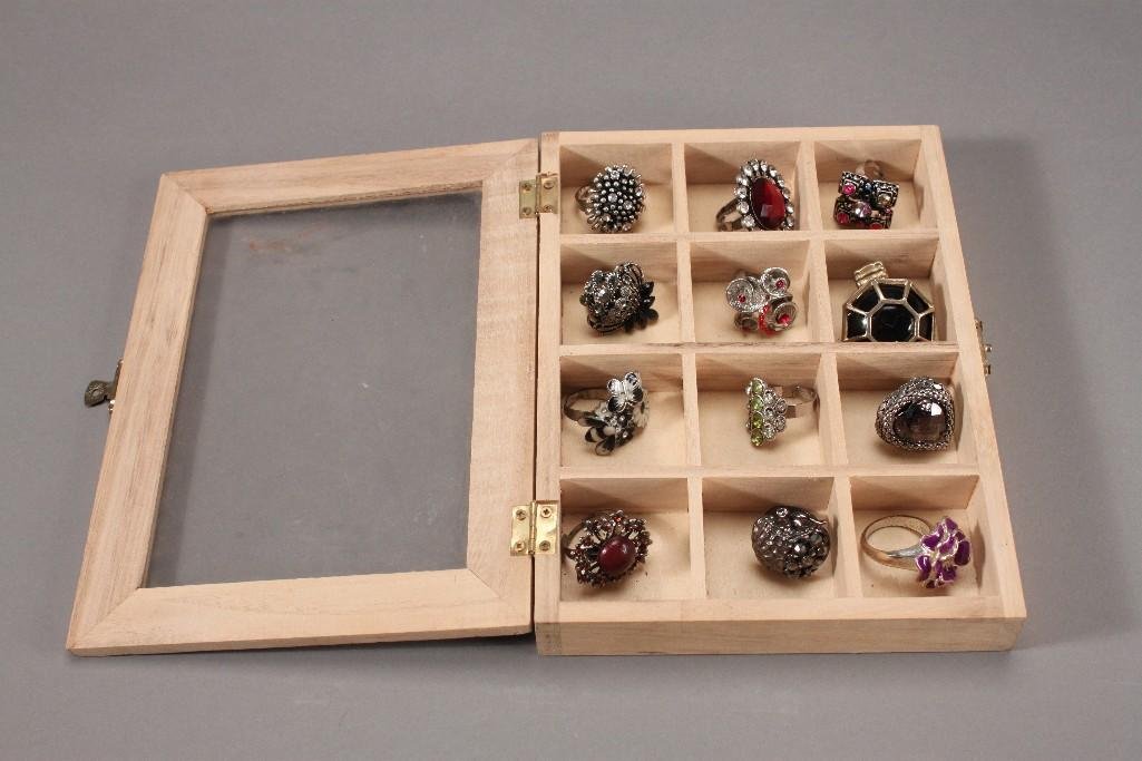 Costume Rings and Ring Box (13): Purple flower ring, apple rhinestone ring, butterfly and flower rhinestone ring, silver tone heart shaped ring, and more. Display box has 12 compartments 8x6''.